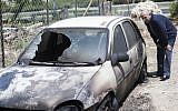 Illustrative photo of a vehicle that was allegedly torched by Israeli settlers in a 'price tag' attack, June 2013. (Yonatan Sindel/Flash90)