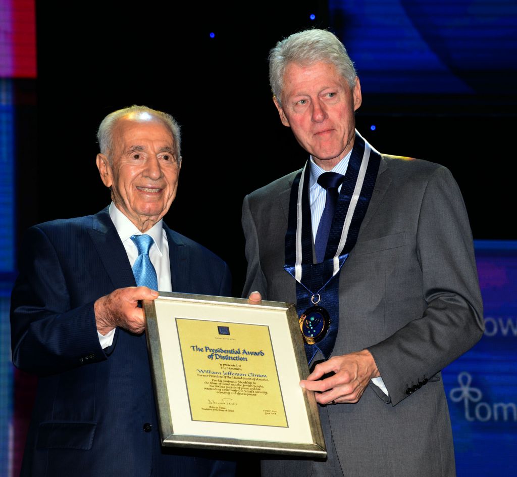 President Shimon Peres awards former president Bill Clinton with the Presidential Medal of Distinction, Wednesday, June 19, 2013 (photo credit: Moshe Milner/GPO/Flash90) President Shimon Peres awards former president Bill Clinton with the Presidential Medal of Distinction, Wednesday, June 19, 2013 (photo credit: Moshe Milner/GPO/Flash90)