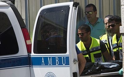Paramedics cart off the body of 46-year-old Doron Ben Shlush who was killed by a security guard at the Western Wall Friday, June 21 (photo credit: Yonatan Sindel/Flash90)