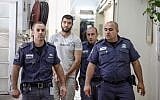 Hadi Kabalan, the security guard who shot and killed a man near the Western Wall, enters the Jerusalem Magistrate's Court for a remand hearing on June 25, 2013. (photo credit: Flash90)