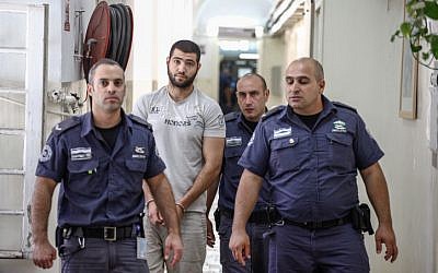 Hadi Kabalan, the security guard who shot and killed a man near the Western Wall, enters the Jerusalem Magistrate's Court for a remand hearing on June 25, 2013. (photo credit: Flash90)