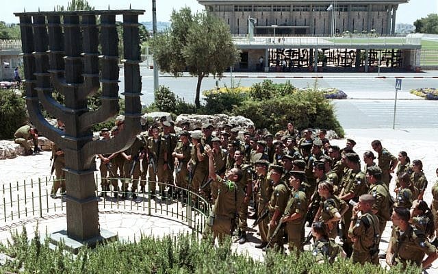 Israel soldiers gather around a large Menorah standing outside the Knesset in 2001. (photo credit: Nati Shohat/Flash90) Israel soldiers gather around a large Menorah standing outside the Knesset in 2001. (photo credit: Nati Shohat/Flash90)
