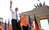 US President Barack Obama and German Chancellor Angela Merkel wave to spectators before Obama delivers a speech in front of the Brandenburg Gate at Pariser Platz in Berlin, Germany, Wednesday June 19, 2013. (AP/Michael Kappeler)
