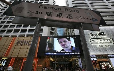 A TV screen shows a news report of Edward Snowden, a former CIA employee who leaked top-secret documents about sweeping U.S. surveillance programs, at a shopping mall in Hong Kong Sunday, June 23 (AP Photo/Vincent Yu)