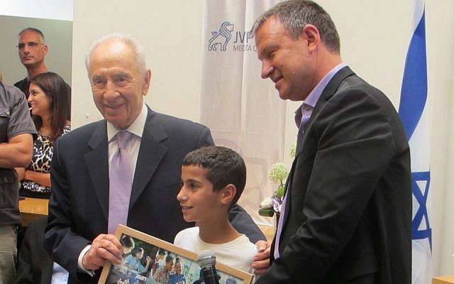 Ofik (center), a young man in JVP's mentor program, is flanked by President Shimon Peres (L) and MK Erel Margalit (Photo credit: Courtesy) Ofik (center), a young man in JVP's mentor program, is flanked by President Shimon Peres (L) and MK Erel Margalit (Photo credit: Courtesy)