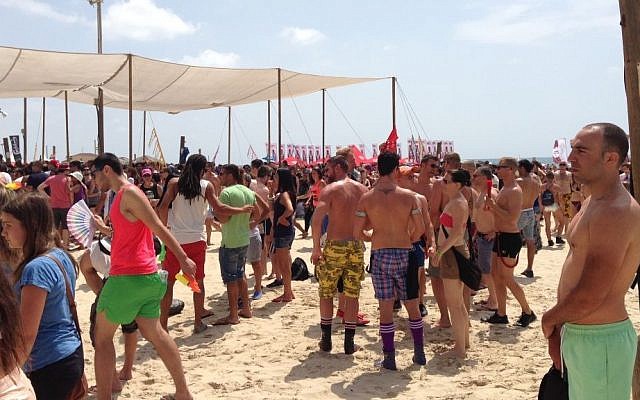 Revelers attend a beach party during the Tel Aviv Pride Festival on Friday (photo credit: Times of Israel staff) Revelers attend a beach party during the Tel Aviv Pride Festival on Friday (photo credit: Times of Israel staff)
