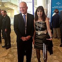 Waiting for cocktails, Portland Trust CEO Eival Gilady and his striped wife (photo credit: Sarah Tuttle-Singer/Times of Israel)