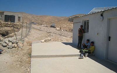 Teens outside the schoolhouse in the Palestinian village of Jinba, south of Hebron, on Tuesday (photo credit: Ilan Ben Zion/Times of Israel staff)