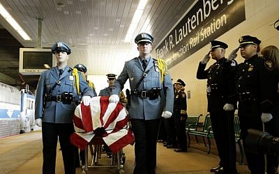 The casket of US Sen. Frank Lautenberg is transferred to an Amtrak train en route to Washington D.C. during a Color Guard ceremony at the Frank R. Lautenberg Rail Station on Wednesday in Secaucus, N.J. (photo credit: AP/Frank Franklin II)