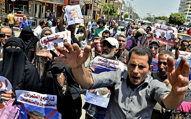 Protesters chant slogans against Egyptian President Mohammed Morsi outside a court in Ismailia, Egypt. (photo credit: AP/Mostafa Darwish, File)