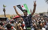 Egyptian Salafis shout slogans against Syrian President Bashar Assad as one waves a Syrian revolutionary flag during a rally after the Friday prayers at Amr Ibn Al As mosque, in Cairo, Egypt, on Friday, June 14, 2013 (photo credit: AP/Amr Nabil)