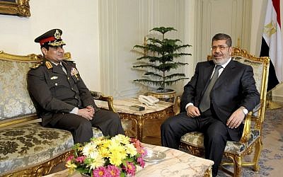 Egyptian Minister of Defense Lt. Gen. Abdel-Fattah al-Sisi meets with Egyptian President Mohammed Morsi at the presidential headquarters in Cairo, Egypt, on Thursday, February 21, 2013. (photo credit: AP/Mohammed Abd El Moaty, Egyptian Presidency)