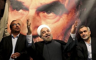 Hasan Rowhani gestures to his supporters at a rally in Tehran on June 1. (photo credit: AP/Ebrahim Noroozi)