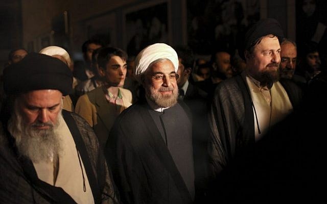 Iranian President elect Hasan Rowhani, center, is accompanied by Hasan Khomeini, grandson of the late revolutionary founder Ayatollah Khomeini, right, and Ayatollah Mousavi Bojnourdi, during visit of Ayatollah Khomeini's shrine, just outside Tehran, Iran, Sunday, June 16, 2013 (photo credit: Ebrahim Noroozi/AP)