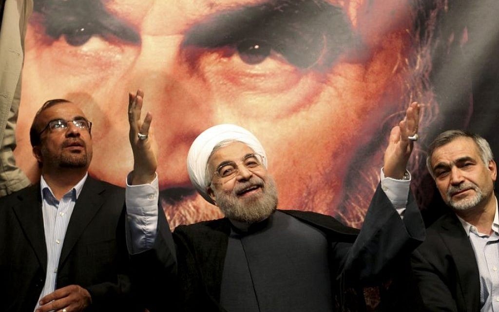 Hasan Rouhani, center, poses before a large portrait of the late Iranian revolutionary founder Ayatollah Khomeini, the day after being elected Iran's president, on June 15, 2013 (AP/Ebrahim Noroozi) Hasan Rouhani, center, poses before a large portrait of the late Iranian revolutionary founder Ayatollah Khomeini, the day after being elected Iran's president, on June 15, 2013 (AP/Ebrahim Noroozi)