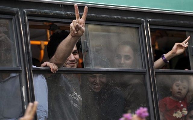 Passengers in a public bus flash victory signs in a reaction of supporters of the Iranian presidential candidate Hasan Rowhani, as they attend a celebration gathering in Tehran on Saturday. (photo credit: AP/Vahid Salemi) Passengers in a public bus flash victory signs in a reaction of supporters of the Iranian presidential candidate Hasan Rowhani, as they attend a celebration gathering in Tehran on Saturday. (photo credit: AP/Vahid Salemi)