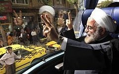Then-presidential candidate Hassan Rouhani waves from a campaign bus in the western city of Sanandaj, Iran, earlier this year (photo credit: AP/Vahid Salemi)
