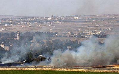 Smoke rises from a fire that resulted from fighting in the Syrian village of Quneitra, near the border with Israel, on June 6, 2013 (photo credit: AP/Sebastian Scheiner)