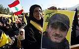 In this picture taken on Saturday May 25, 2013, a Hezbollah supporter holds a portrait of her son, Ibrahim Kanso, 24, who was killed 40 days before, at Sayida Zeinab shrine during a battle in Syria against the Syrian rebels (photo credit:AP/Hussein Mella)