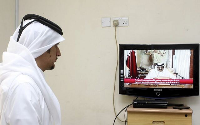 A man watches a televised address by Qatar's Emir Sheik Hamad bin Khalifa Al Thani, in Doha, Qatar,Tuesday, June 25, 2013 (photo credit: AP/Osama Faisal) A man watches a televised address by Qatar's Emir Sheik Hamad bin Khalifa Al Thani, in Doha, Qatar,Tuesday, June 25, 2013 (photo credit: AP/Osama Faisal)