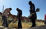Syrian rebels prepare to fire locally made rockets in Idlib province, northern Syria (photo credit: AP/Edlib News Network ENN)