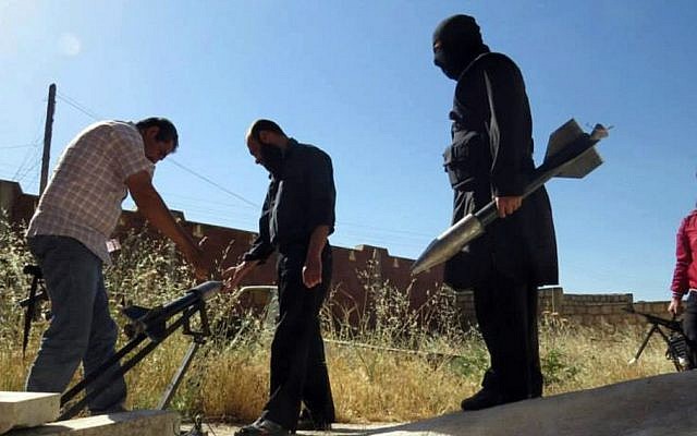 Syrian rebels prepare to fire locally made rockets in Idlib province, northern Syria (photo credit: AP/Edlib News Network ENN) Syrian rebels prepare to fire locally made rockets in Idlib province, northern Syria (photo credit: AP/Edlib News Network ENN)