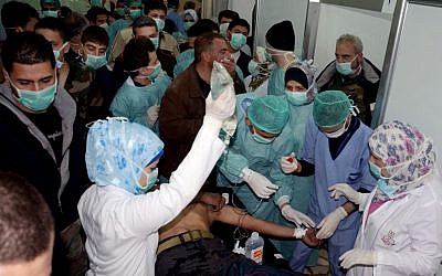 A Syrian victim who suffered an alleged chemical attack at Khan al-Assal village receives treatment by doctors at a hospital in Aleppo, Syria, on March 19, 2013. (photo credit: AP/SANA, File)
