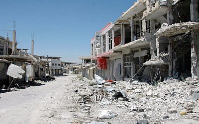 A damaged street in Qusair, Syria (photo credit: AP/SANA)