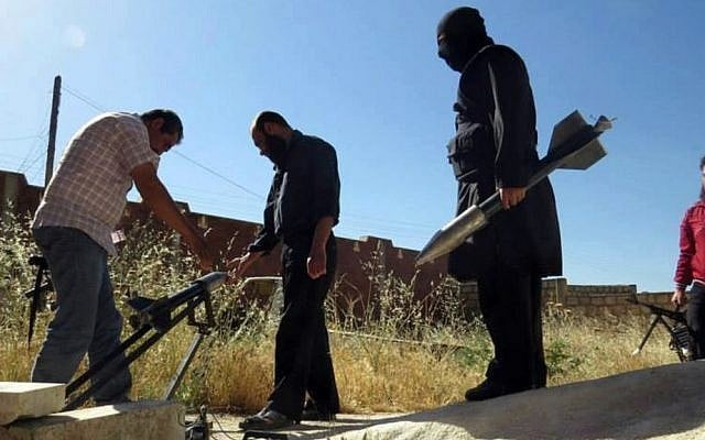Syrian rebels preparing to fire locally made rockets, in Idlib province, northern Syria (photo credit: AP/Edlib News Network ENN) Syrian rebels preparing to fire locally made rockets, in Idlib province, northern Syria (photo credit: AP/Edlib News Network ENN)