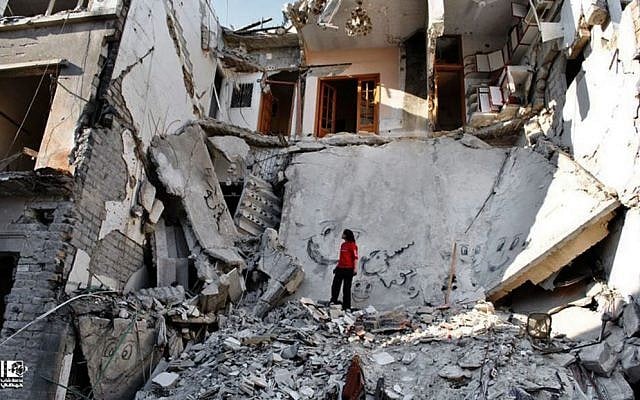 A Syrian standing in the rubble of a destroyed building from Syrian forces shelling, in the al-Hamidiyyeh neighborhood of Homs province, Syria, on Thursday, June 27, 2013. (photo credit: AP Photo/Lens Young Homsi) A Syrian standing in the rubble of a destroyed building from Syrian forces shelling, in the al-Hamidiyyeh neighborhood of Homs province, Syria, on Thursday, June 27, 2013. (photo credit: AP Photo/Lens Young Homsi)