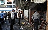 In this photo released by the Syrian official news agency SANA, Syrians inspect a damaged shop at a scene of two explosions in the central district of Marjeh, Damascus, Syria, Tuesday, June 11, 2013 (photo credit: AP/SANA)