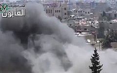 This image made from amateur video released by Ugarit News, which has been authenticated based on its contents and other AP reporting, shows smoke rises in Damascus, Syria, Friday, June 21, 2013. (Photo credit: AP/Ugarit News via AP video)