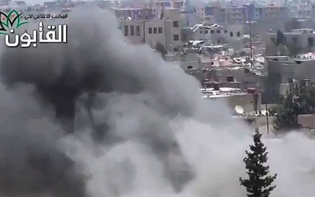 This image made from amateur video released by Ugarit News, which has been authenticated based on its contents and other AP reporting, shows smoke rises in Damascus, Syria, Friday, June 21, 2013. (Photo credit: AP/Ugarit News via AP video)