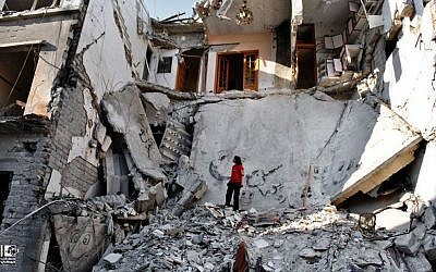 A Syrian standing in the rubble of destroyed buildings from Syrian forces shelling, Syria, Thursday, June 27, 2013. (photo credit:AP/Lens Young Homsi)
