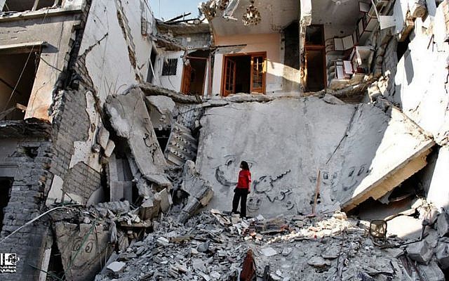 A Syrian standing in the rubble of destroyed buildings from Syrian forces shelling, Syria, Thursday, June 27, 2013. (photo credit:AP/Lens Young Homsi) A Syrian standing in the rubble of destroyed buildings from Syrian forces shelling, Syria, Thursday, June 27, 2013. (photo credit:AP/Lens Young Homsi)