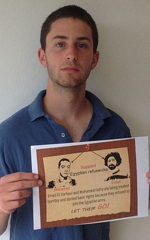 Israeli conscientious objector Nathan Blanc holds up a sign supporting Dafrawi and Fathy (photo credit: courtesy/Shimri Zameret/Yesh Gvul) Israeli conscientious objector Nathan Blanc holds up a sign supporting Dafrawi and Fathy (photo credit: courtesy/Shimri Zameret/Yesh Gvul)