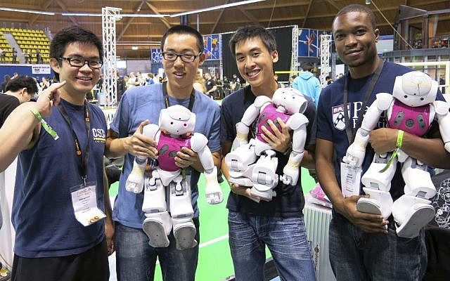 Chris Akatsuka, Dickens He, Alan Aquino and Tatenda Mushonga from the University of Pennsylvania's "UPennalizer" team show off their robots at the RoboCup championships in Eindhoven, Netherlands, on June 27, 2013. (photo credit: AP Photo/Toby Sterling) Chris Akatsuka, Dickens He, Alan Aquino and Tatenda Mushonga from the University of Pennsylvania's "UPennalizer" team show off their robots at the RoboCup championships in Eindhoven, Netherlands, on June 27, 2013. (photo credit: AP Photo/Toby Sterling)