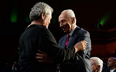Israeli singer Shlomo Artzi congratulates Israeli President Shimon Peres after performing at a celebration in honor of Peres's 90th birthday, in Jerusalem, June 18, 2013. (photo credit: Kobi Gideon/GPO/Flash90)