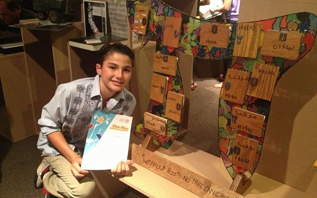 Gianni Mizrahi, 11, from San Diego, CA, poses with his first-place winning display for 'My Family Story,' a competition held by the Beit Hatfutsot, the Museum of the Jewish People, in Tel Aviv (photo credit: Leeor Bronis/Times of Israel) Gianni Mizrahi, 11, from San Diego, CA, poses with his first-place winning display for 'My Family Story,' a competition held by the Beit Hatfutsot, the Museum of the Jewish People, in Tel Aviv (photo credit: Leeor Bronis/Times of Israel)