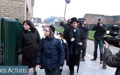 Rabbi Moshe Aryeh Friedman and his family arrive at the Yesode Hatora School in Antwerp, Belgium. (YouTube screenshot/File)