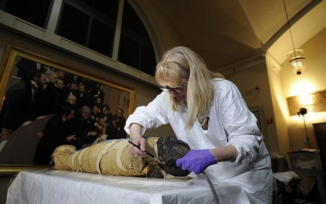 Mimi Leveque, a freelance conservator, cleans Padihershef, a 2,500-year-old Egyptian mummy at Mass General Hospital in Boston, Friday, June 7, 2013. (photo credit: AP/Gretchen Ertl) 