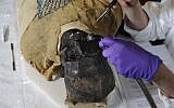 Mimi Leveque, a freelance conservator, cleans Padihershef, a 2,500-year-old Egyptian mummy at Mass General Hospital in Boston, Friday, June 7, 2013. (photo credit: AP/Gretchen Ertl)