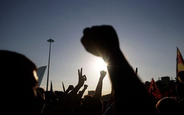 Protesters raise their hands as they shout slogans during a protest at Taksim Square in Istanbul, on Monday, June 3, 2013. (photo credit: AP Photo/Kostas Tsironis) Protesters raise their hands as they shout slogans during a protest at Taksim Square in Istanbul, on Monday, June 3, 2013. (photo credit: AP Photo/Kostas Tsironis)