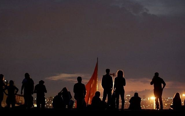 Protesters stand on the roof of Ataturk Cultural center during a protest at Taksim square in Istanbul, Tuesday, June 4 (photo credit: AP/Kostas Tsironis) Protesters stand on the roof of Ataturk Cultural center during a protest at Taksim square in Istanbul, Tuesday, June 4 (photo credit: AP/Kostas Tsironis)