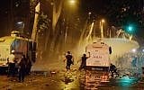 In this photo taken late Saturday, June 1, 2013, Turkish protesters clash with riot police near the former Ottoman palace, Dolmabahce, where Turkey's Prime Minister Recep Tayyip Erdogan maintains an office in Istanbul, Turkey. (photo credit: AP)