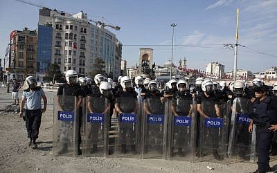 Turkish riot policemen take their position during clashes in Taksim Square in Istanbul on Tuesday, June 11, 2013. (photo credit/Kostas Tsironis/AP) 