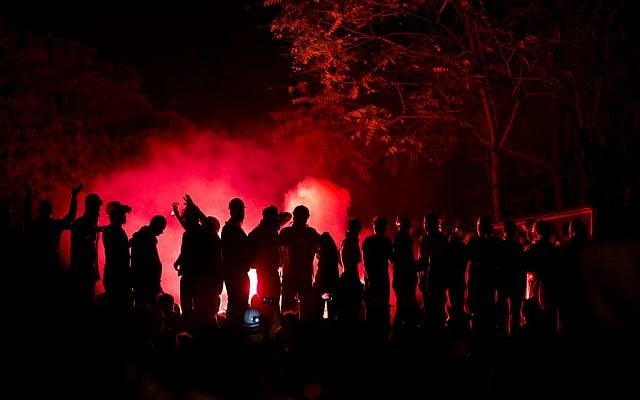 Protesters chant anti-government slogans, silhouetted by the light of flares in Taksim square, in Istanbul, Turkey, late Wednesday, June 12 (photo credit: AP/Vadim Ghirda) Protesters chant anti-government slogans, silhouetted by the light of flares in Taksim square, in Istanbul, Turkey, late Wednesday, June 12 (photo credit: AP/Vadim Ghirda)