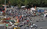 Pedestrians mill around the Gezi park off the Taksim Square as a few protesters gather at a barricade in Istanbul, on Thursday, June 13, 2013. (photo credit: AP Photo/Thanassis Stavrakis)