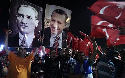 Supporters of the AKP, Justice and Development party hold the portraits of Mustafa Kemal Ataturk, founder of Turkey and Turkish Prime Minister Recep Tayyip Erdogan at the Ataturk Airport of Istanbul early Friday, June 7, 2013. (AP Photo/Thanassis Stavrakis)