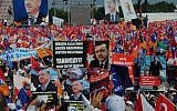 Supporters of Turkish Prime Minister Recep Tayyip Erdogan wave his posters before he arrives to address a party rally in Istanbul on Sunday, June 16, 2013. The banner at the center reads: 'We are with you.' (photo credit: Burhan Ozbilici/AP)